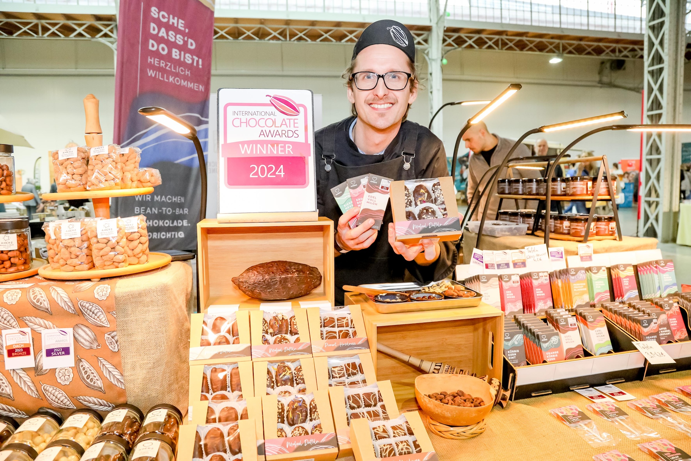 Michael Salge von der Schokomanufaktur AHerz setzt konsequent auf das Bean-to-Bar-Prinzip. Von der Kakaobohne bis zur fertigen Tafel entsteht jede Schokolade in eigener Handarbeit – ein Ansatz, der Qualität, Transparenz und Herkunft in den Mittelpunkt stellt.